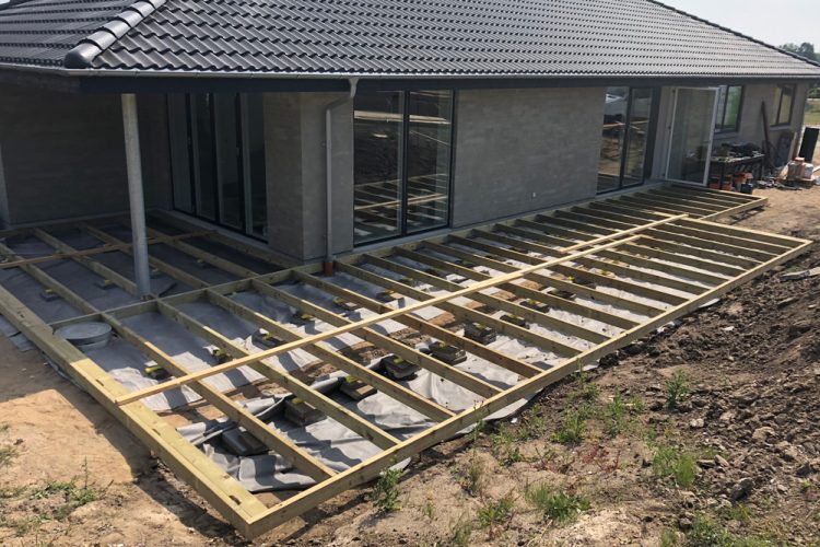 Foundation frame for an L-shaped wooden deck.